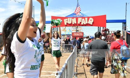 SANTA MONICA, CALIFORNIA - JUNE 29: Fans are greeted by Hawkins High School cheerleaders at the Netflix's "Stranger Things" Season 3 Fun Fair at Santa Monica Pier on June 29, 2019 in Santa Monica, California. (Photo by Amy Sussman/Getty Images)
