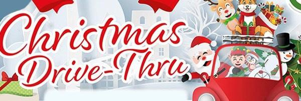 Festive holiday drive-thru event with Christmas decorations and cheerful characters.