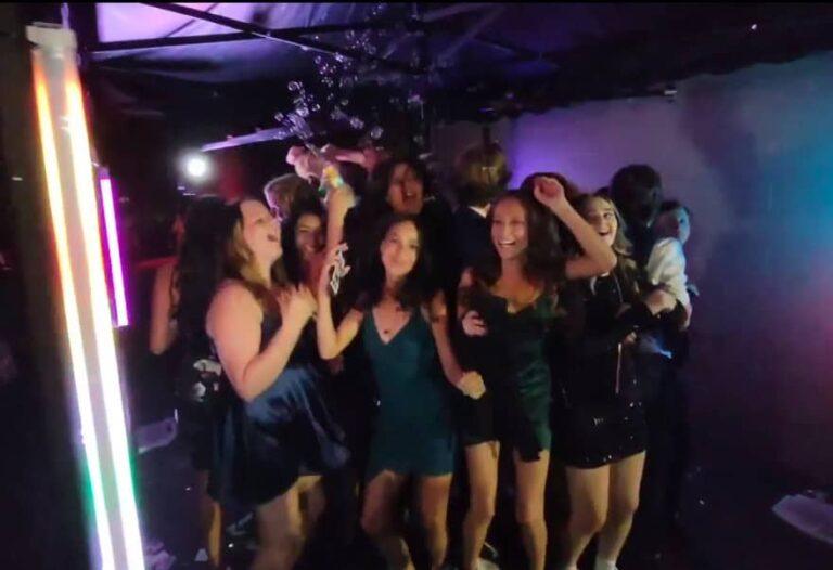 Selfie cam capturing guests enjoying the 360 photo experience at a lively party.