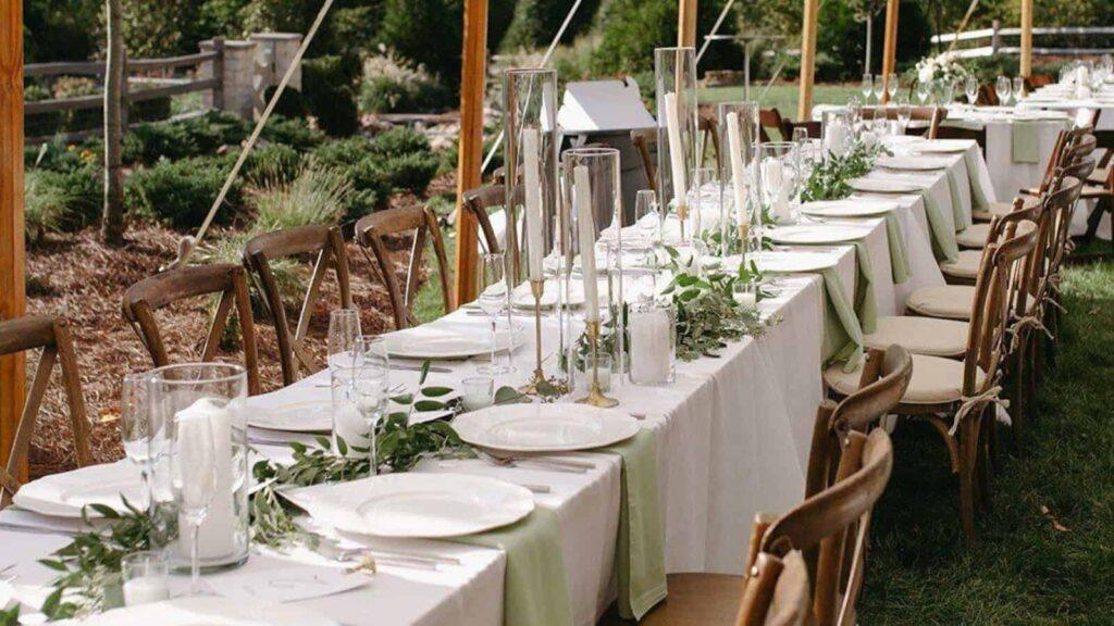 Outdoor event table with white linens, floral decor, and elegant tableware in Los Angeles.