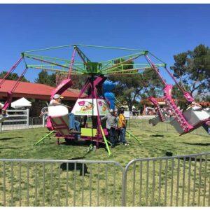 Amusement park ride featuring colorful swings and a central rotating structure, perfect for outdoor.