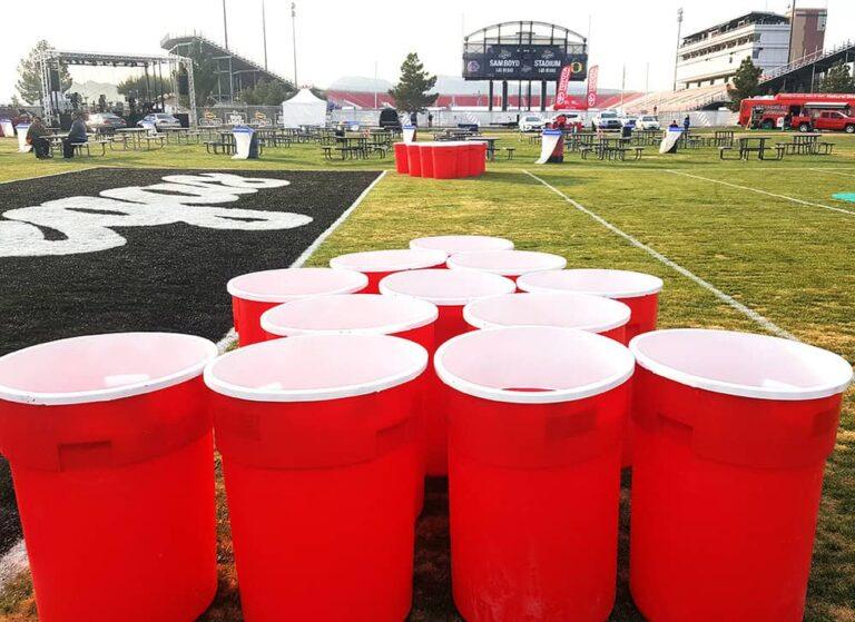 Large red cups for giant beer pong at outdoor events.