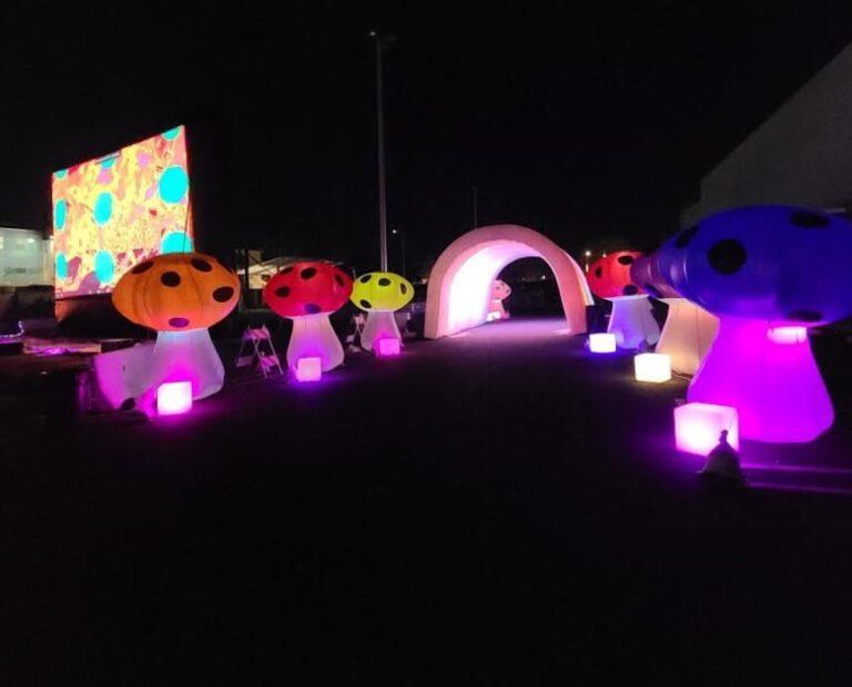 LED mushroom-shaped lights illuminated in vibrant colors at night. Perfect for enhancing outdoor eve.